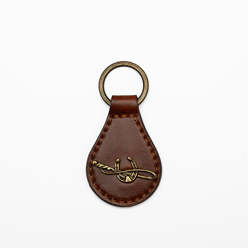 Keychain with riding whip and horseshoe